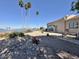 Waterfront backyard features desert landscaping, patio, and serene views of the adjacent lake at 15720 S Lanai Cir, Arizona City, AZ 85123