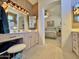 Bathroom with double vanity, archway to the bedroom, and abundant vanity lighting at 15720 S Lanai Cir, Arizona City, AZ 85123