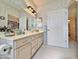 Spacious bathroom features a large mirror, vanity, and a doorway to another room at 15720 S Lanai Cir, Arizona City, AZ 85123
