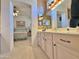 Double vanity bathroom with bright lighting and an arched doorway to the bedroom at 15720 S Lanai Cir, Arizona City, AZ 85123