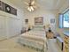 Comfortable bedroom featuring a ceiling fan, closet, dresser, and natural light from the window at 15720 S Lanai Cir, Arizona City, AZ 85123