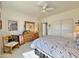 Bright bedroom features a ceiling fan, bed, dresser, and closet at 15720 S Lanai Cir, Arizona City, AZ 85123
