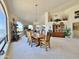 Well-lit dining room with water views, stylish chandelier, and seamless transition to the living area at 15720 S Lanai Cir, Arizona City, AZ 85123