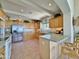 Functional kitchen equipped with light wood cabinets, tile floors, stainless steel refrigerator, and ample counter space at 15720 S Lanai Cir, Arizona City, AZ 85123