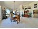 Open living space featuring large picture windows and a traditional dining set at 15720 S Lanai Cir, Arizona City, AZ 85123