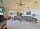 Spacious living room with vaulted ceilings, neutral carpet, comfortable seating, and ample natural light at 15720 S Lanai Cir, Arizona City, AZ 85123