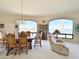 Open living space with traditional decor, large picture windows and a cozy recliner at 15720 S Lanai Cir, Arizona City, AZ 85123