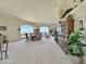 Open-concept living room with lake views, dining area, and built-in display case at 15720 S Lanai Cir, Arizona City, AZ 85123