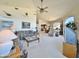 Bright living room showcasing vaulted ceilings and an open layout leading to the dining and kitchen area at 15720 S Lanai Cir, Arizona City, AZ 85123