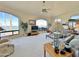 Bright living room featuring large windows with water views, vaulted ceilings, and comfortable seating at 15720 S Lanai Cir, Arizona City, AZ 85123