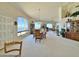 Bright open living space with large windows overlooking the lake and formal dining area at 15720 S Lanai Cir, Arizona City, AZ 85123