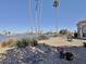 This home's backyard landscape includes waterfront views and drought tolerant landscaping at 15720 S Lanai Cir, Arizona City, AZ 85123