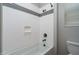 A clean bathroom featuring a tub with shower, white tile, and chrome fixtures at 16227 W Mariposa Grande --, Surprise, AZ 85387