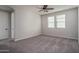 Spacious carpeted bedroom featuring two large windows and ample natural light at 16227 W Mariposa Grande --, Surprise, AZ 85387