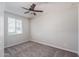 Neutral bedroom with a ceiling fan and a window letting in lots of natural light at 16227 W Mariposa Grande --, Surprise, AZ 85387