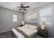 Bedroom featuring bed with tufted headboard, side tables with lamps, and natural light from windows at 16227 W Mariposa Grande --, Surprise, AZ 85387