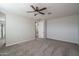 Spacious bedroom with neutral tones, ceiling fan, and doorway leading to an adjacent room at 16227 W Mariposa Grande --, Surprise, AZ 85387