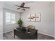 Well-lit bedroom showcasing a desk, office chair, and a leafy plant near the window at 16227 W Mariposa Grande --, Surprise, AZ 85387