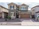 Two-story home featuring a two-car garage, low maintenance landscaping, and neutral color palette at 16227 W Mariposa Grande --, Surprise, AZ 85387
