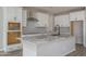 Kitchen featuring white cabinets, granite countertops and stainless steel vent hood at 16227 W Mariposa Grande --, Surprise, AZ 85387