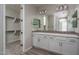 Bathroom featuring a double sink vanity with white cabinets and tile backsplash at 16277 W Mariposa Grande --, Surprise, AZ 85387