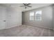 Spacious carpeted bedroom with natural light and ceiling fan at 16277 W Mariposa Grande --, Surprise, AZ 85387