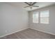Neutral bedroom with carpet, fan and two windows offering natural light at 16277 W Mariposa Grande --, Surprise, AZ 85387