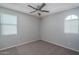 Neutral bedroom with carpet, fan and two windows offering natural light at 16277 W Mariposa Grande --, Surprise, AZ 85387