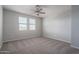 Spacious bedroom with neutral carpet, a ceiling fan and large windows offering natural light at 16277 W Mariposa Grande --, Surprise, AZ 85387