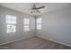Bright bedroom with neutral carpet, three windows offering natural light, and a ceiling fan at 16277 W Mariposa Grande --, Surprise, AZ 85387