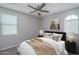 Neutral bedroom featuring carpet, fan and two windows offering natural light at 16277 W Mariposa Grande --, Surprise, AZ 85387