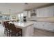 Bright kitchen featuring white cabinets, a center island with chairs, and stainless steel appliances at 16277 W Mariposa Grande --, Surprise, AZ 85387