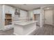 Bright kitchen featuring white cabinets, stainless steel appliances, and a center island with a sink at 16277 W Mariposa Grande --, Surprise, AZ 85387