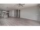 Open-concept living area with vinyl floors and a view of the kitchen and staircase at 16277 W Mariposa Grande --, Surprise, AZ 85387