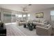 Cozy living room with neutral furniture, a ceiling fan, and a sliding glass door at 16277 W Mariposa Grande --, Surprise, AZ 85387
