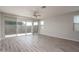 Open living area with a sliding glass door and vinyl floors at 16277 W Mariposa Grande --, Surprise, AZ 85387