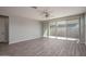 Open living area with a sliding glass door and vinyl floors at 16277 W Mariposa Grande --, Surprise, AZ 85387