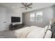 Bedroom with natural light, a ceiling fan, large bed and a TV mounted on the wall at 16277 W Mariposa Grande --, Surprise, AZ 85387