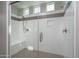 Modern walk-in shower featuring gray tile accents, a built-in seat, and convenient storage niche at 16277 W Mariposa Grande --, Surprise, AZ 85387