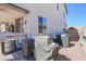 View of covered outdoor kitchen, and patio, and rock landscaping in backyard at 16763 W Adams St, Goodyear, AZ 85338