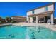 Beautiful backyard featuring a swimming pool, covered patio, outdoor kitchen, and putting green for endless enjoyment at 16763 W Adams St, Goodyear, AZ 85338