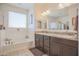 Elegant bathroom features a soaking tub, dual sinks, and granite countertops for a luxurious feel at 16763 W Adams St, Goodyear, AZ 85338