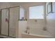 Bright bathroom with large soaking tub, glass enclosed shower, and modern fixtures at 16763 W Adams St, Goodyear, AZ 85338