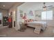 Cozy bedroom featuring carpet floors, ceiling fan, and unique decorations, creating a welcoming and personalized space at 16763 W Adams St, Goodyear, AZ 85338