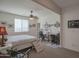 Bedroom with ceiling fan, a sewing station, and view of the desert out the windows at 16763 W Adams St, Goodyear, AZ 85338