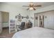 Bright bedroom with a ceiling fan, a work desk for hobbyists, and a view into the connected bathroom at 16763 W Adams St, Goodyear, AZ 85338