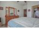 Inviting bedroom featuring a dresser with a mirror and a ceiling fan, creating a serene and functional living space at 16763 W Adams St, Goodyear, AZ 85338