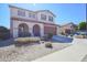 Charming two-story home with desert landscaping, a tile roof and a two-car garage at 16763 W Adams St, Goodyear, AZ 85338