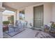 Cozy covered front porch featuring stylish seating and a welcoming entryway at 16763 W Adams St, Goodyear, AZ 85338
