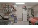 Cluttered garage with storage shelves, a refrigerator, and several boxed items at 16763 W Adams St, Goodyear, AZ 85338